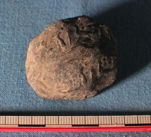 Clay cork sealed with Assyrian cylinder seal, from pit in Area P.